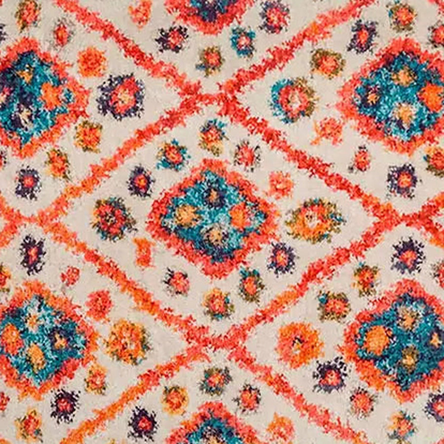 Gros plan sur le velours du tapis berbère coloré anya, orange et turquoise